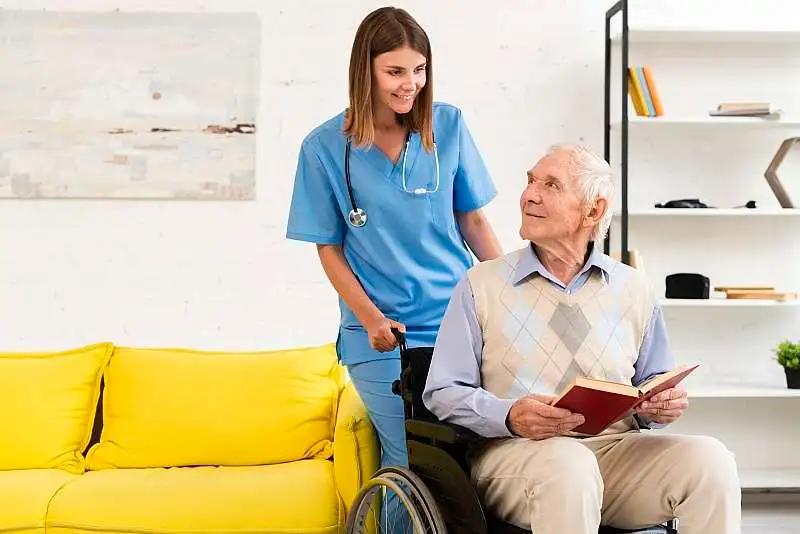A caregiver talking with a client in a wheelchair